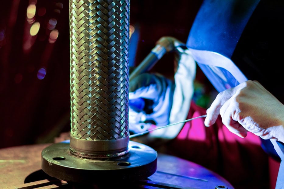 McGill ASME-qualified welder fabricating a stainless steel hose assembly
